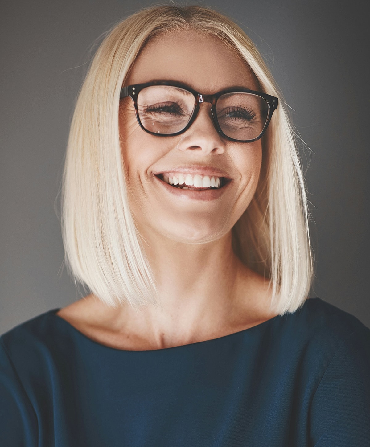 Fayetteville Deep Plane Facelift model with glasses and short blonde hair.