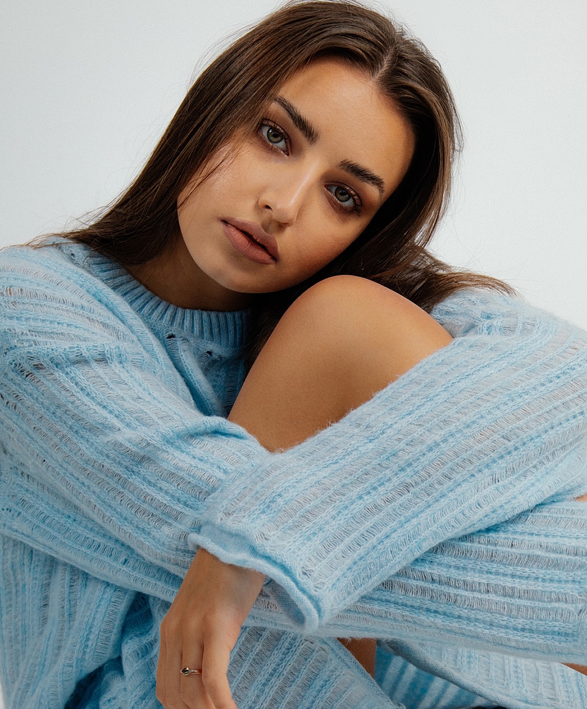 Fayetteville Laser Skin Resurfacing model in blue sweater posing thoughtfully.