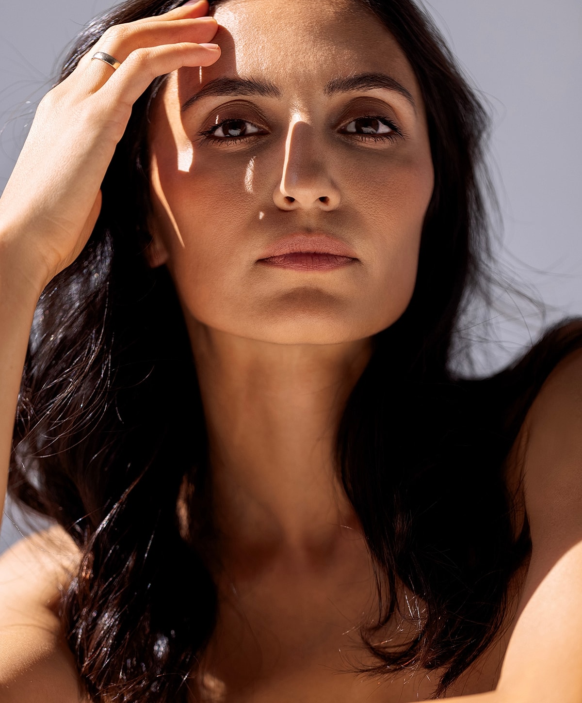 Fayetteville Microneedling model with long hair in a white top.