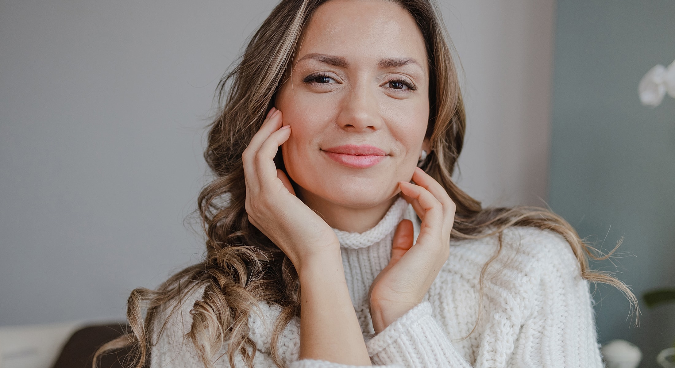 Fayetteville Rhinoplasty model with hands on her face.